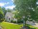 Front exterior of a two-story home with mature trees and a well-kept lawn at 1 Lake Hill Dr, Durham, NC 27713