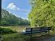 Relaxing lake view from a community bench, surrounded by lush greenery and a tranquil atmosphere at 1 Lake Hill Dr, Durham, NC 27713
