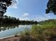 Breathtaking view of the tranquil lake, framed by lush trees, creating a peaceful and scenic environment at 1 Lake Hill Dr, Durham, NC 27713