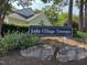 Community sign for Lake Village Townes with manicured landscaping that enhances curb appeal and neighborhood pride at 1 Lake Hill Dr, Durham, NC 27713