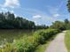 Enjoy scenic walking trails alongside the lake, surrounded by lush greenery and colorful flowers, perfect for relaxation at 1 Lake Hill Dr, Durham, NC 27713