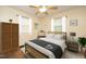 This staged bedroom features a ceiling fan, a bed with a wicker frame, and two dark grey nightstands at 106 Eugene St, Carrboro, NC 27510
