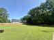 Expansive backyard featuring a lush lawn, privacy fence, and mature trees creating a private outdoor space at 109 N Watauga Ave, Dunn, NC 28334