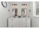 Elegant bathroom with dual sinks, marble countertop, and decorative mirrors at 109 N Watauga Ave, Dunn, NC 28334