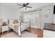 Cozy bedroom boasts a metal bed frame, wood floors, natural light, and stylish decor at 109 N Watauga Ave, Dunn, NC 28334