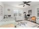 Bright bedroom with shark-themed decor, a cozy bed, a desk, and an area rug on wood floors at 109 N Watauga Ave, Dunn, NC 28334
