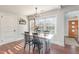 Bright and airy dining room with hardwood floors, a modern chandelier, and natural light at 109 N Watauga Ave, Dunn, NC 28334