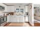 Modern kitchen featuring stainless steel appliances, white cabinets, and hardwood floors at 109 N Watauga Ave, Dunn, NC 28334