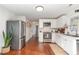 Bright kitchen with stainless steel appliances, white cabinets and hardware, and hardwood floors at 109 N Watauga Ave, Dunn, NC 28334