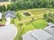 Aerial view showcases a home near a neighborhood pond and green space at 1124 Cedar Farm Trl, Fuquay Varina, NC 27526