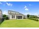 Expansive backyard with a large lawn, screened-in porch, and green landscaping at 1124 Cedar Farm Trl, Fuquay Varina, NC 27526