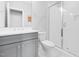Clean bathroom featuring gray cabinets, white countertops, and a glass walk-in shower at 1124 Cedar Farm Trl, Fuquay Varina, NC 27526