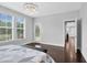 Tranquil bedroom with ample natural light, chandelier, and hardwood floors offers a peaceful retreat at 1124 Cedar Farm Trl, Fuquay Varina, NC 27526