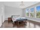 Spacious primary bedroom features hardwood floors and a chandelier, offering ample natural light at 1124 Cedar Farm Trl, Fuquay Varina, NC 27526