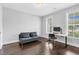 Versatile home office space with a futon, desk, and natural light from two windows at 1124 Cedar Farm Trl, Fuquay Varina, NC 27526