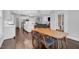 Open-concept dining room and kitchen flow to living space with dark hardwood flooring at 1124 Cedar Farm Trl, Fuquay Varina, NC 27526