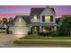 Charming two-story home with a well-manicured lawn and a welcoming front porch at 1124 Cedar Farm Trl, Fuquay Varina, NC 27526