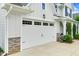 Spacious two-car garage with stone accents and manicured landscaping at 1124 Cedar Farm Trl, Fuquay Varina, NC 27526
