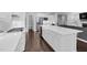 Open-concept kitchen boasts stainless steel appliances, a farmhouse sink, and a gas range at 1124 Cedar Farm Trl, Fuquay Varina, NC 27526