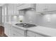 Bright kitchen features modern gas range, white subway tile backsplash, and stainless steel range hood at 1124 Cedar Farm Trl, Fuquay Varina, NC 27526