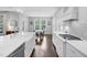 Well-lit, modern kitchen with gas range, farmhouse sink, and adjacent dining area at 1124 Cedar Farm Trl, Fuquay Varina, NC 27526