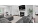 Inviting living room featuring a fireplace and a cozy gray sectional sofa at 1124 Cedar Farm Trl, Fuquay Varina, NC 27526