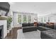 Bright living room with large windows, fireplace, and comfortable seating arrangement at 1124 Cedar Farm Trl, Fuquay Varina, NC 27526