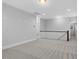 Upstairs loft area features neutral walls and carpet with trim; natural light makes it spacious at 1124 Cedar Farm Trl, Fuquay Varina, NC 27526
