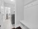Bright mudroom features storage bench, coat hooks and connects to laundry area with shelving in this modern, neutral home at 1124 Cedar Farm Trl, Fuquay Varina, NC 27526