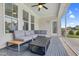 Covered porch with tiled floor and comfortable seating at 1124 Cedar Farm Trl, Fuquay Varina, NC 27526