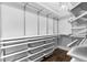 Organized walk-in closet featuring white shelving, drawers, and ample storage space at 1124 Cedar Farm Trl, Fuquay Varina, NC 27526