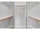 Unfurnished walk-in closet with custom wooden shelving offering optimal storage and organization at 1124 Cedar Farm Trl, Fuquay Varina, NC 27526
