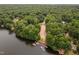 Aerial view of a community boat launch and docks on a tranquil lake, surrounded by lush greenery at 114 Crow Dr, Louisburg, NC 27549