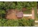 Aerial view of home with well-maintained lawn and long driveway, surrounded by lush trees providing privacy at 114 Crow Dr, Louisburg, NC 27549