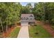 Aerial view of a two-story home with a garage, surrounded by a lush landscape at 114 Crow Dr, Louisburg, NC 27549