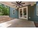 Covered back patio with ceiling fan overlooks the yard and is accessed via glass french doors at 114 Crow Dr, Louisburg, NC 27549