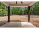 View from the covered back patio looks out over the spacious backyard surrounded by mature trees at 114 Crow Dr, Louisburg, NC 27549