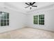 Bright bedroom featuring neutral carpet, tray ceiling, and well-lit windows with pleasant views at 114 Crow Dr, Louisburg, NC 27549