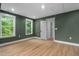 Bedroom with wood floors, green walls, recessed lighting and plenty of natural light from two windows at 114 Crow Dr, Louisburg, NC 27549