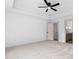 Neutral-toned bedroom with carpet, a ceiling fan, and a doorway leading to a bathroom area at 114 Crow Dr, Louisburg, NC 27549