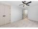 Bright, carpeted bedroom with ceiling fan and closet; door opens to a staircase at 114 Crow Dr, Louisburg, NC 27549