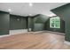 Spacious bonus room with fresh green paint, wood floors, window seat and natural light at 114 Crow Dr, Louisburg, NC 27549