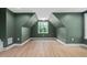 Large bonus room features fresh paint, wood floors, natural light from a window and recessed lights at 114 Crow Dr, Louisburg, NC 27549
