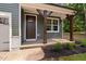 Close up of the entryway with a wooden front door and natural wood columns at 114 Crow Dr, Louisburg, NC 27549