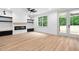 Bright living room showcasing a modern fireplace and access to the outdoors at 114 Crow Dr, Louisburg, NC 27549