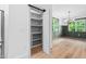 Walk-in pantry with shelving, next to adjacent dining room with a bright window at 114 Crow Dr, Louisburg, NC 27549