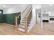 Wooden staircase with metal spindles, leading to the upper level at 114 Crow Dr, Louisburg, NC 27549