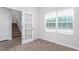 Comfortable bedroom featuring plush carpeting and abundant natural light from a large window at 11640 International Dr, Middlesex, NC 27557