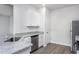 Modern kitchen featuring stainless steel appliances, ample counter space, and sleek white cabinets at 11640 International Dr, Middlesex, NC 27557