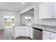 Bright kitchen with stainless steel appliances, granite countertops, and white cabinetry at 11640 International Dr, Middlesex, NC 27557